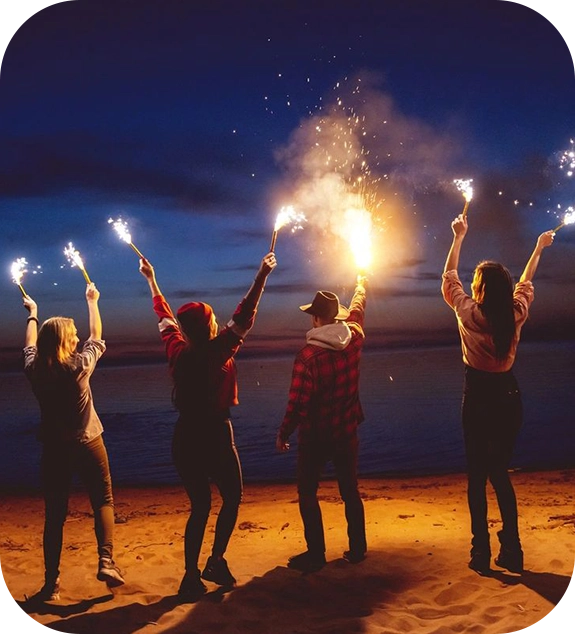 A group of people standing on top of a beach.