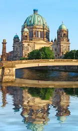 A bridge and building in the background with water