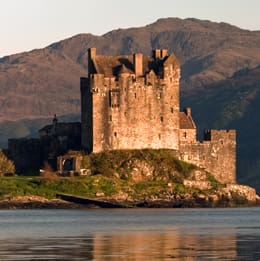 A castle sits on top of a hill.