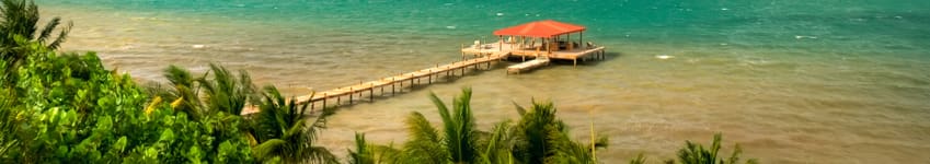 A pier with chairs and an umbrella on it