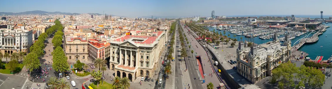 A view of the city from above shows a street with many cars and buildings.