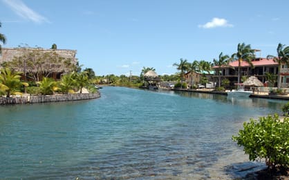 A river with houses on the side of it.