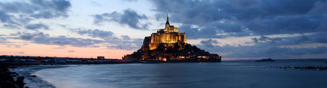 A castle on top of a hill with lights