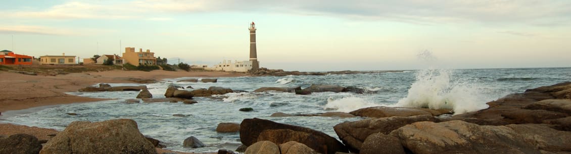 A lighthouse is seen from the water.