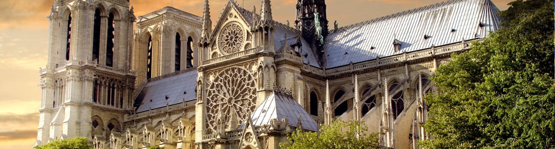 A large cathedral with a clock tower and a massive clock.