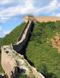 A very long wall on top of a hill.