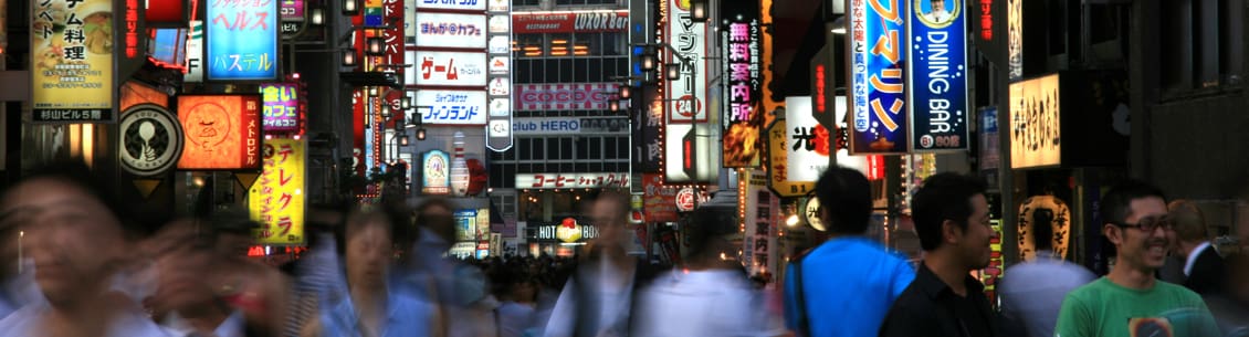 A blurry picture of people walking in the street.