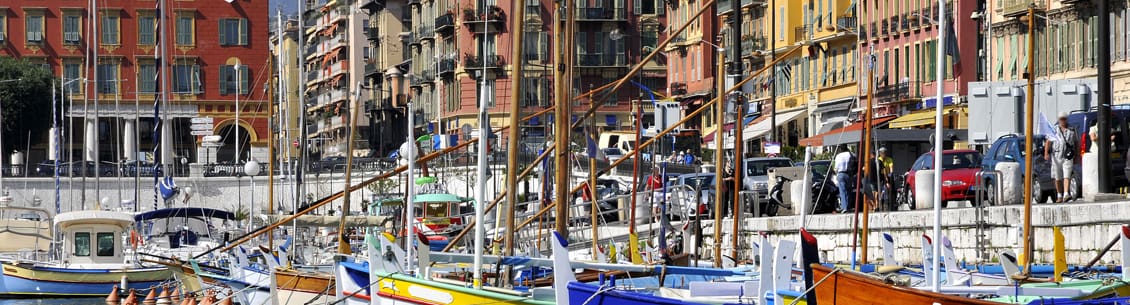 A harbor with many boats and buildings in the background.