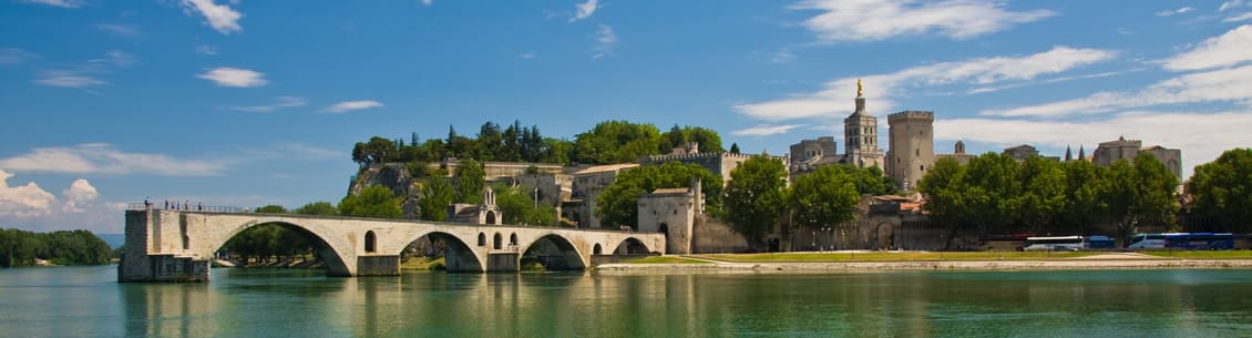 A bridge over water with trees in the background