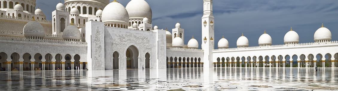 A white building with many domes and pillars