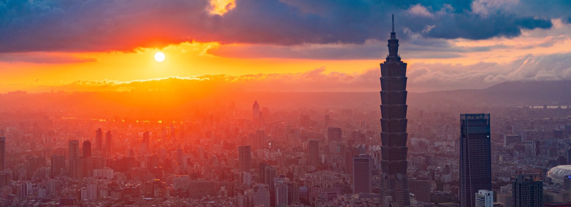 Here's an alt tag for the image: Taipei 101 sunset cityscape.