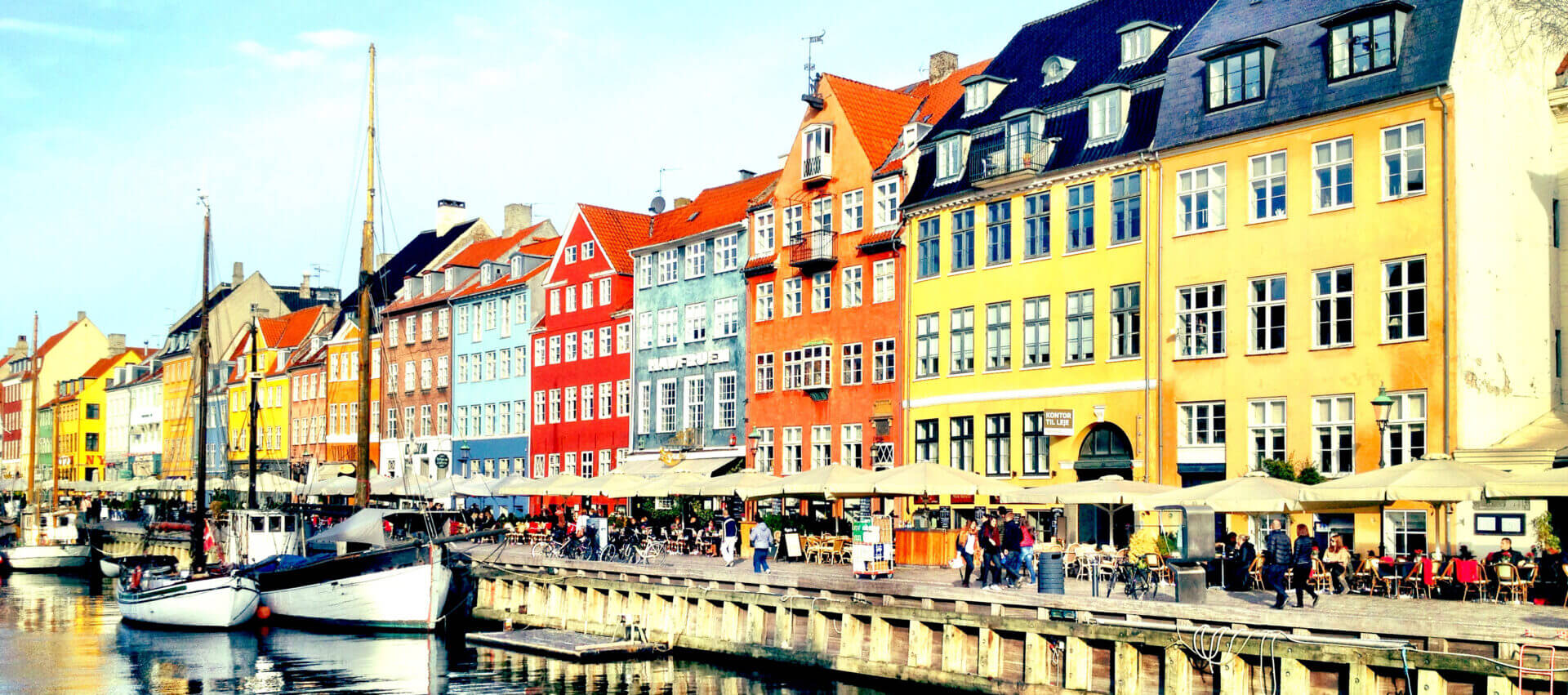 Colorful buildings along a waterfront canal.