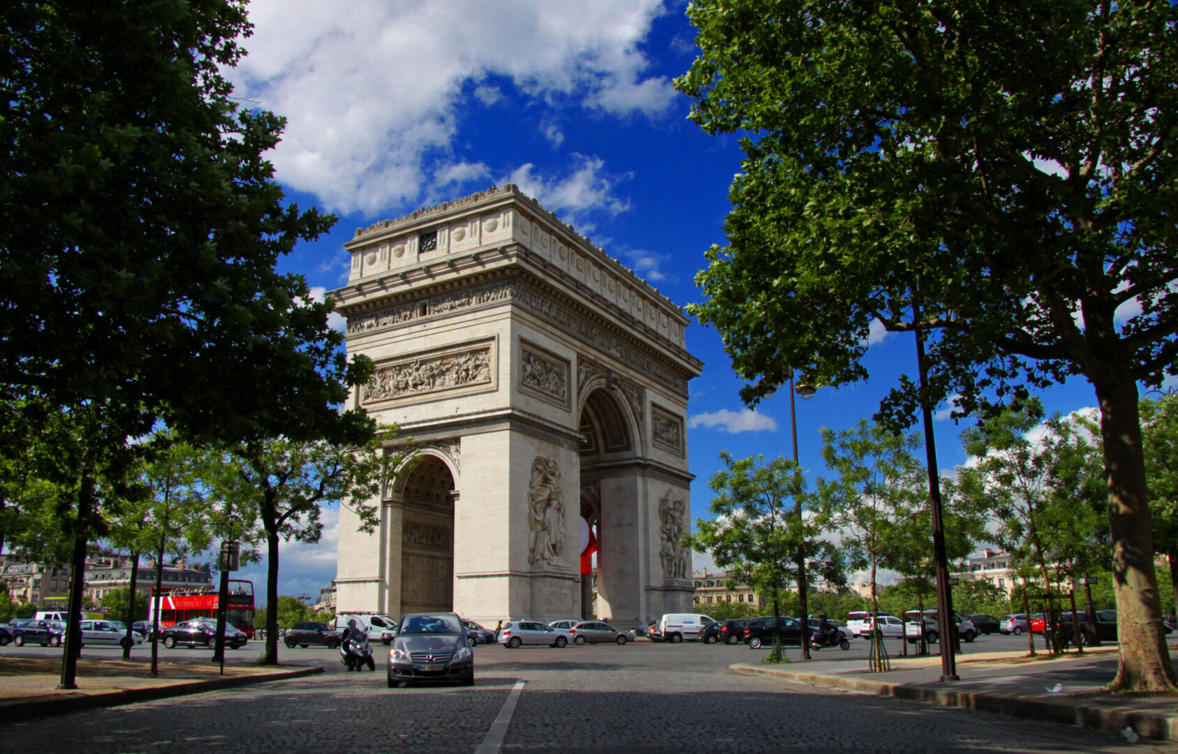 Arc de Triomphe with trees and cars